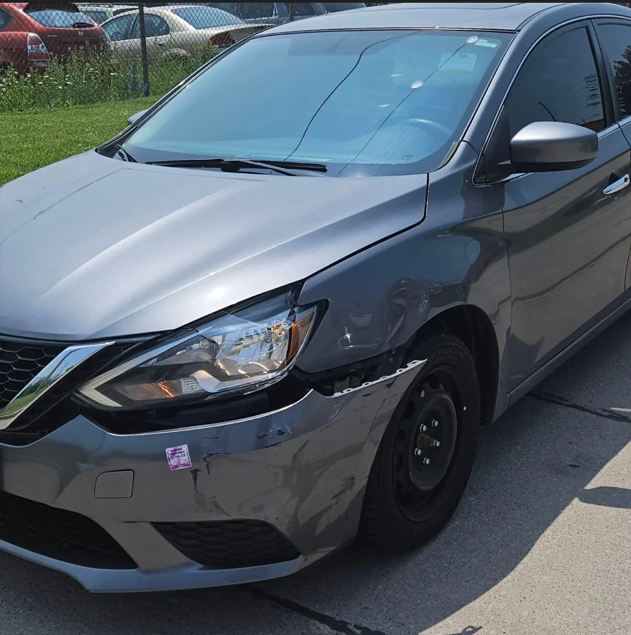 Front of a grey car in the shop